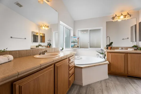 a bathroom with a sink double vanity granite and a mirror