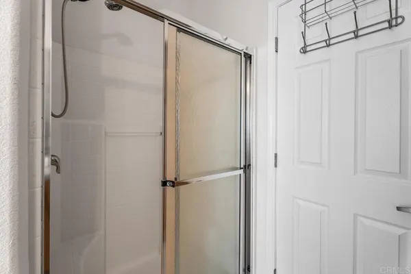 a bathroom with a glass shower door