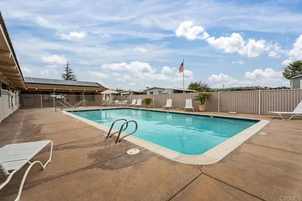 a view of a swimming pool with a yard