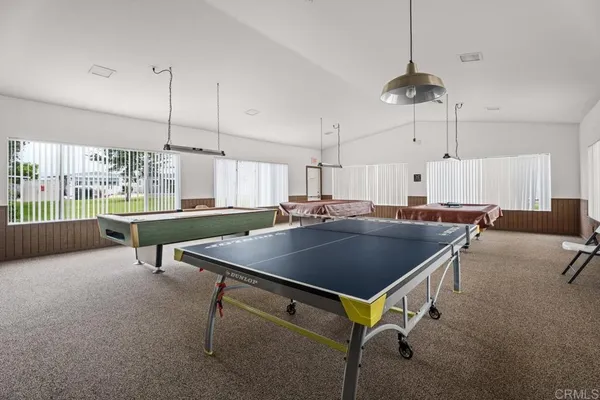 a room with pool table and windows