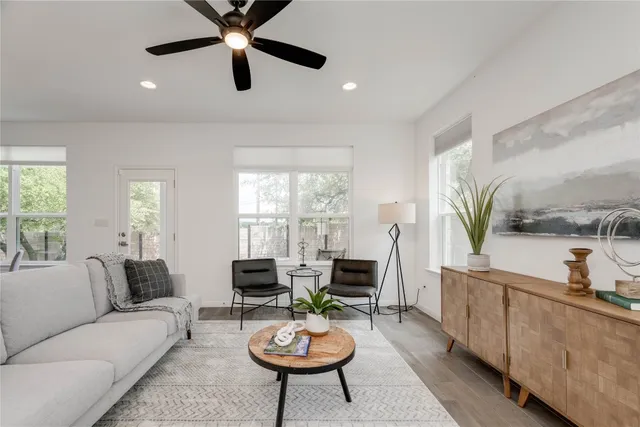 a living room with furniture a window and a chandelier