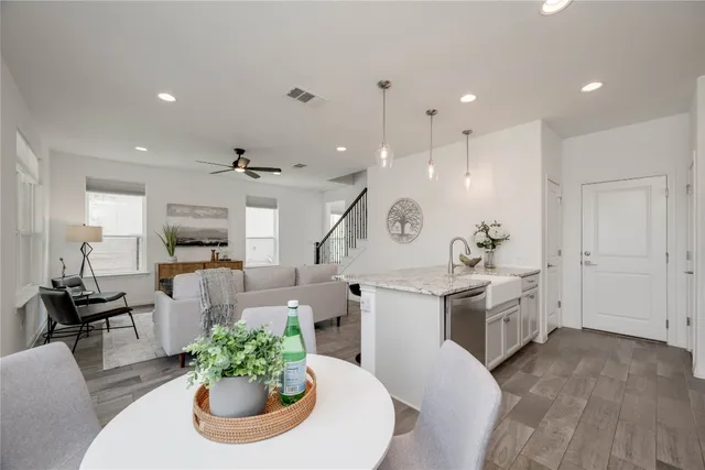a large kitchen with a table and chairs
