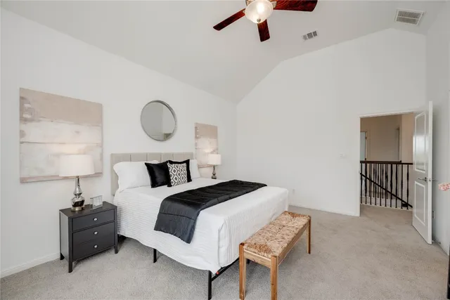 a bedroom with bed and a chandelier