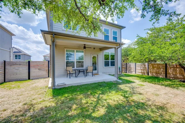 a view of a house with a yard and sitting area