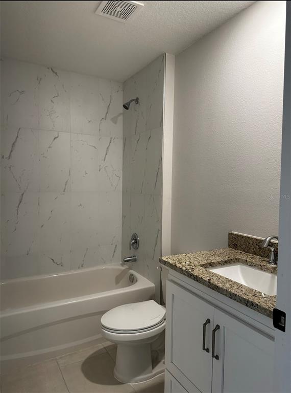 1450 5th Avenue DeLand, FL 32724 - Photo 11 of 16 a bathroom with a granite countertop toilet sink and mirror