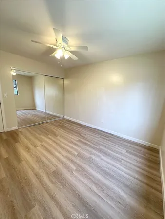 an empty room with fan and fan