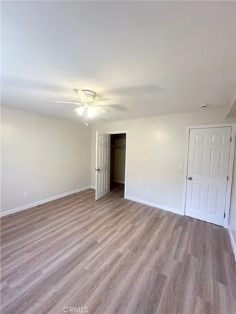 a view of an empty room and wooden floor