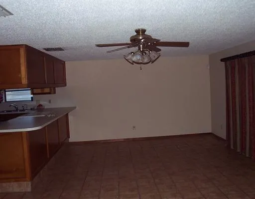 a view of a kitchen with a sink and cabinets