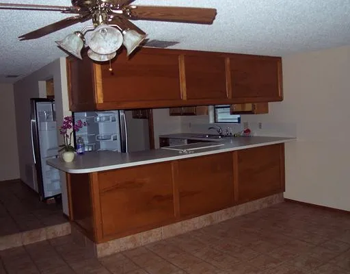 a kitchen with stainless steel appliances granite countertop a sink wooden cabinets and a granite counter top