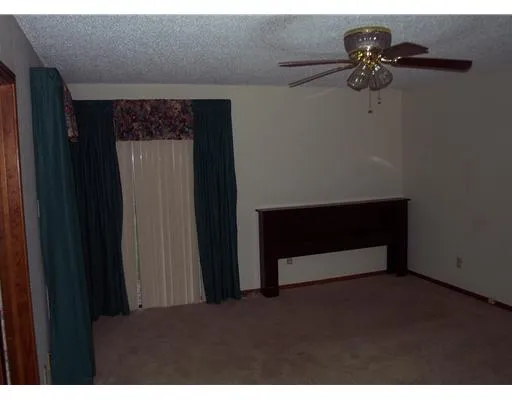 a living room with a bed and a chandelier