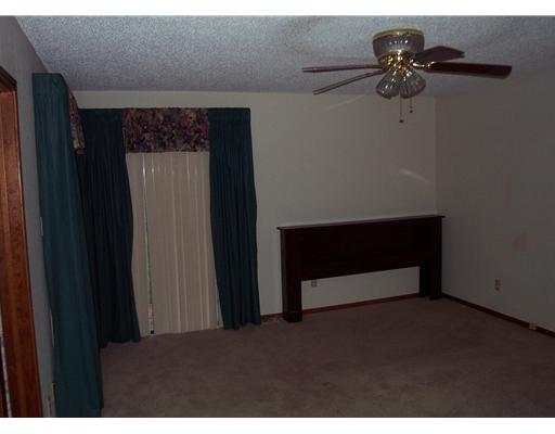 4925 Valley Stream Drive Corpus Christi, TX 78413 - Photo 8 of 10 a living room with a bed and a chandelier