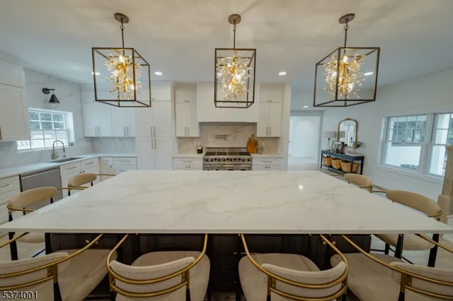 a living room with a couch and a chandelier