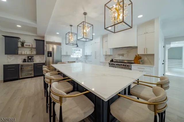 a kitchen with a table chairs sink and cabinets