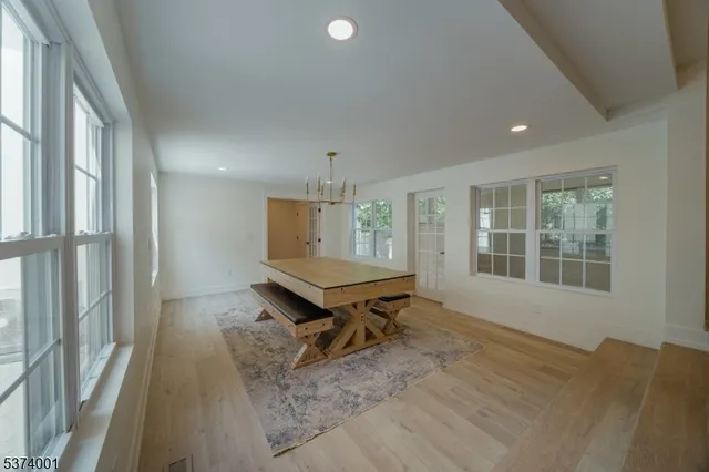 a living room with a table chairs and entryway