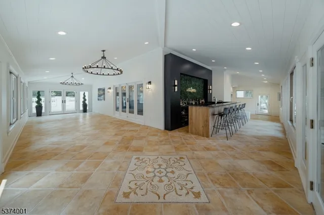a view of a kitchen with a dining table chairs and refrigerator