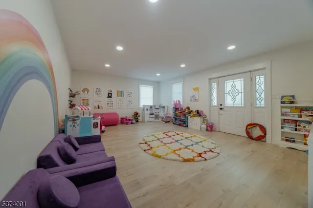 a living room with furniture and a pool table