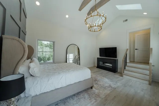 a bedroom with a bed and a television