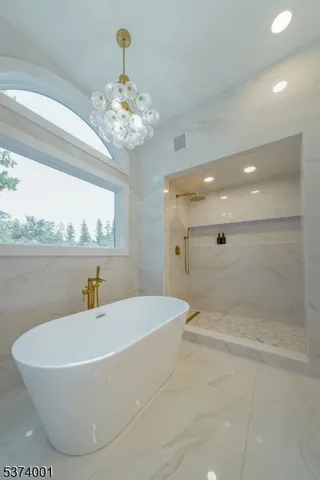 a white bath tub sitting next to a bathroom