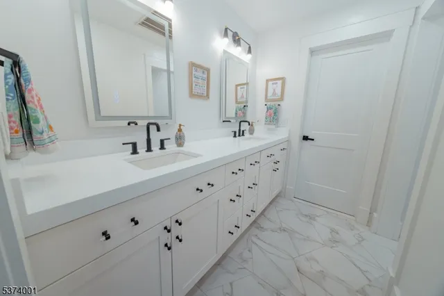 a bathroom with a double vanity sink and mirror
