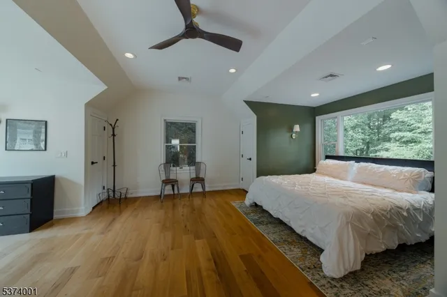 a bedroom with a bed and a large window