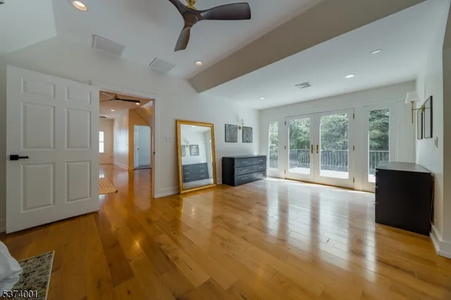 a view of an empty room with glass door and windows