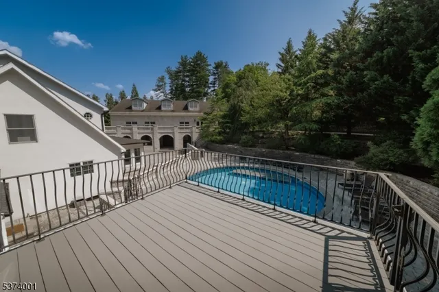 a view of balcony with wooden floor and fence