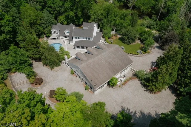 an aerial view of a house with a yard and garden