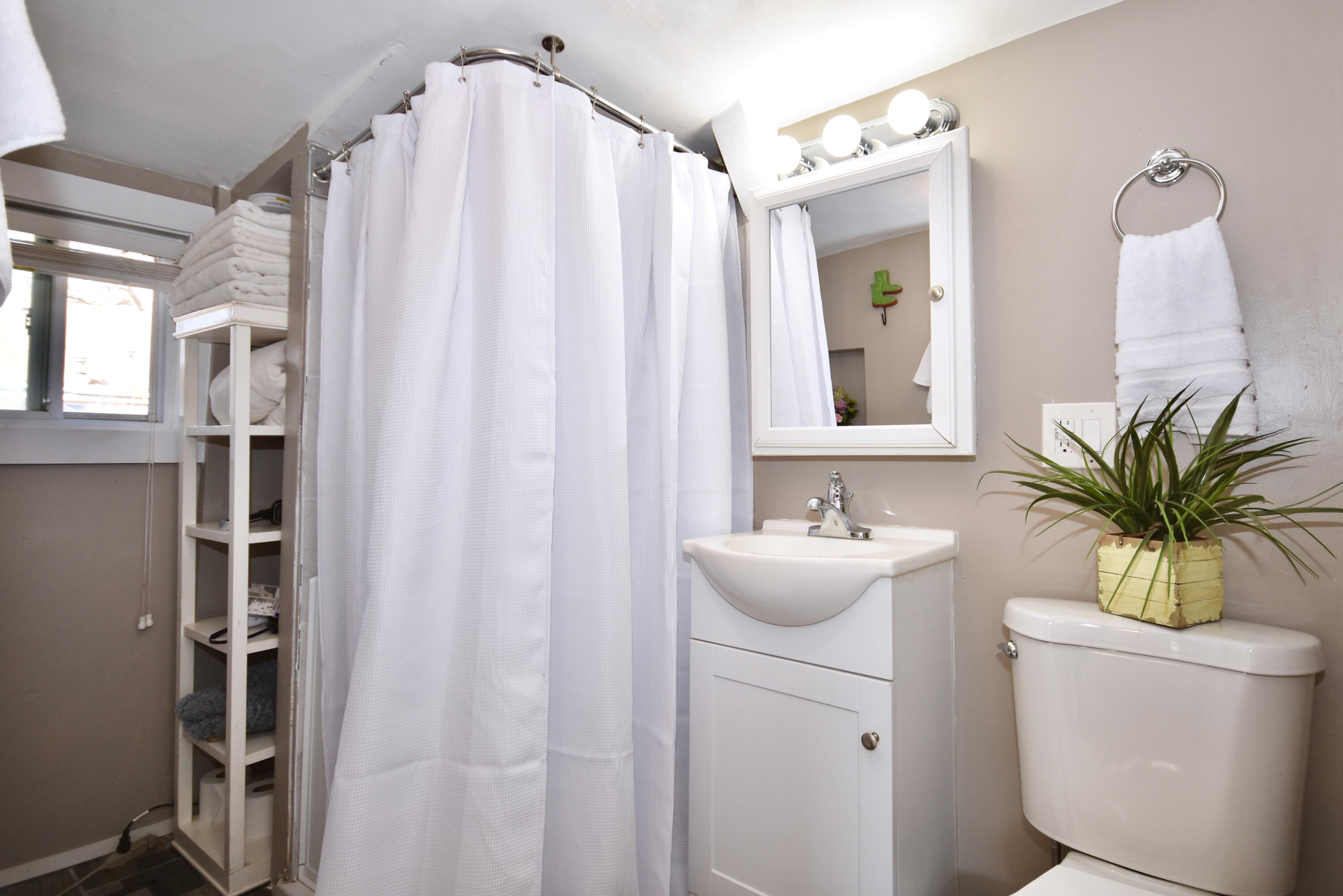 23 Barnes Street Wareham, MA 02571 - Photo 14 of 18 a bathroom with a sink a mirror and a shower curtain