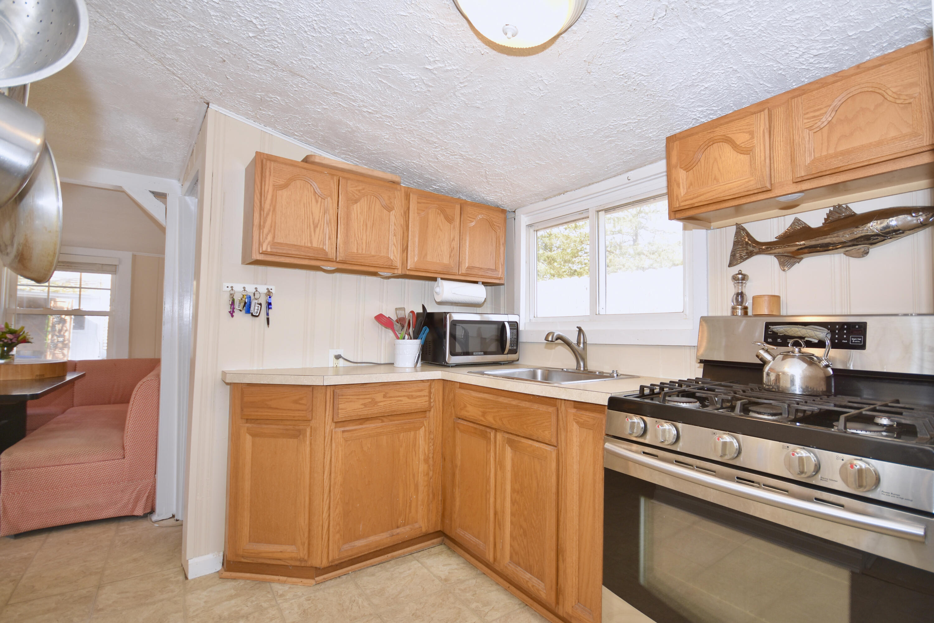 23 Barnes Street Wareham, MA 02571 - Photo 7 of 18 a kitchen with granite countertop a sink a stove and cabinets