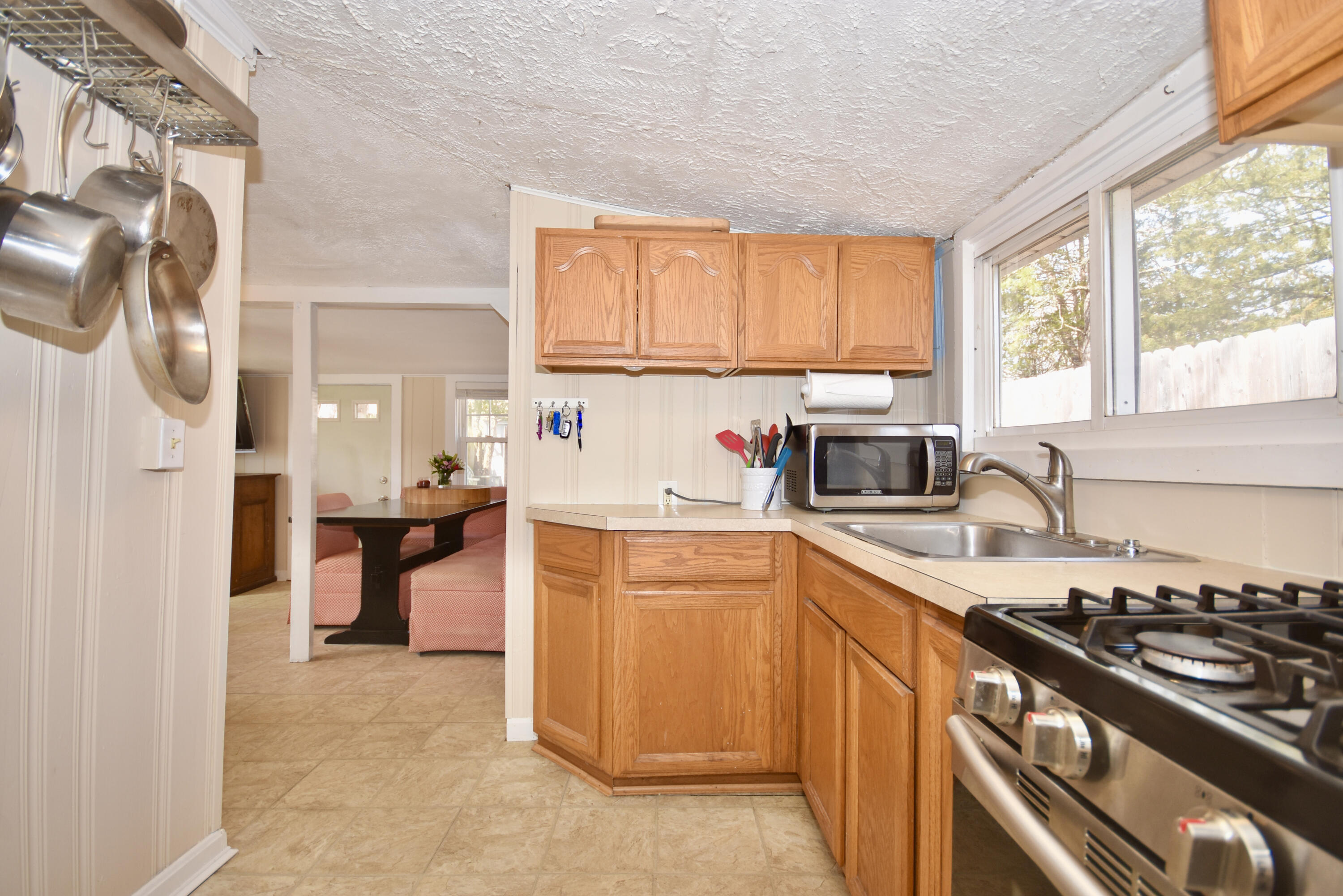 23 Barnes Street Wareham, MA 02571 - Photo 8 of 18 a kitchen with a sink stove top oven and cabinets