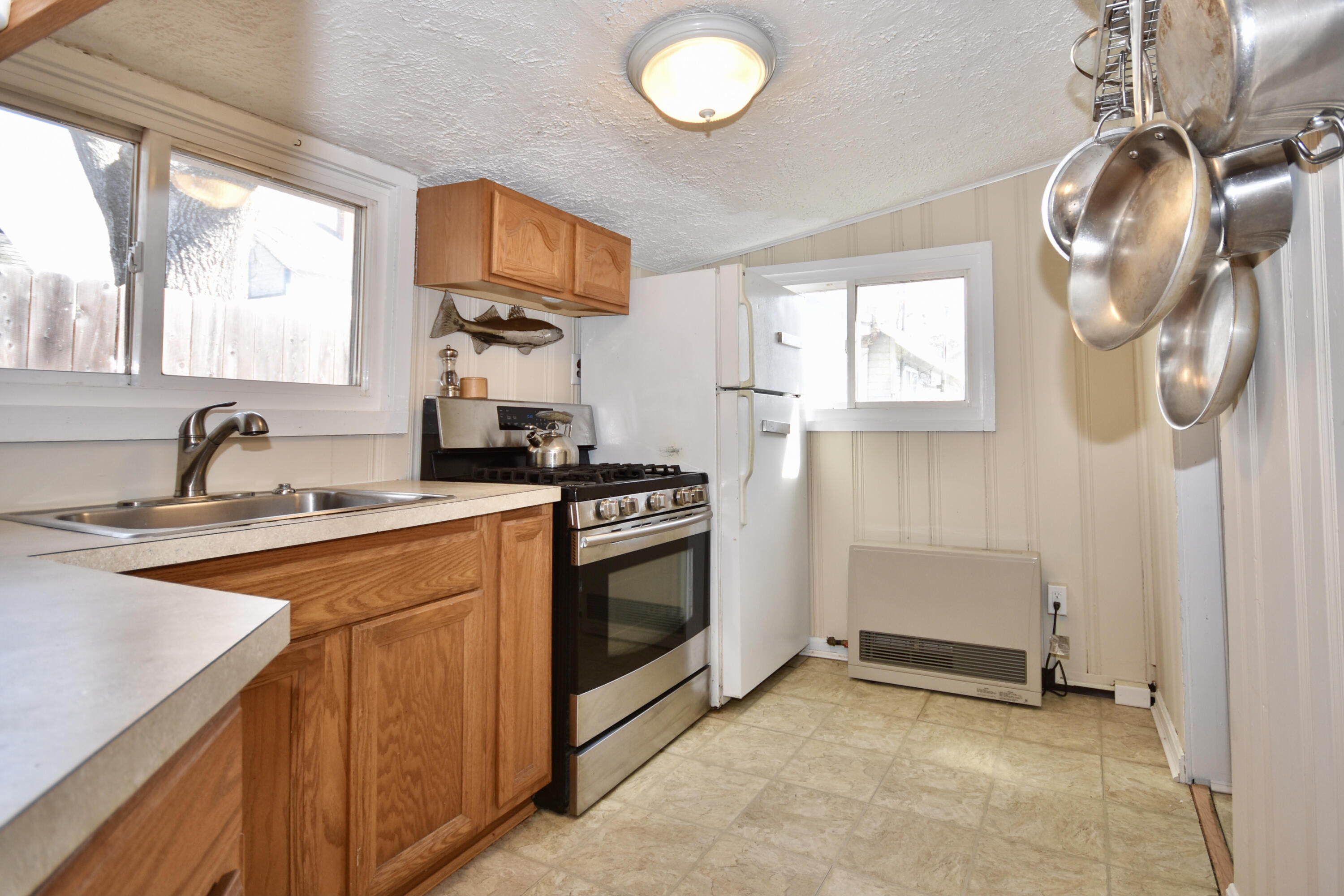 23 Barnes Street Wareham, MA 02571 - Photo 9 of 18 a kitchen that has a sink and a stove