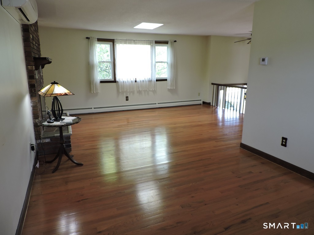269 Griffin Road South Windsor, CT 06074 - Photo 10 of 36 a view of empty room with wooden floor and fan