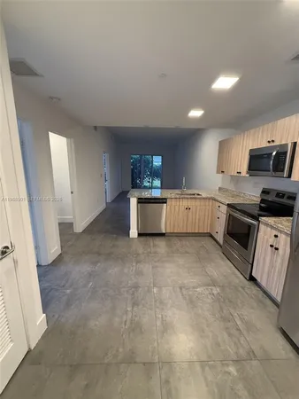 a kitchen with stainless steel appliances granite countertop a stove and a sink
