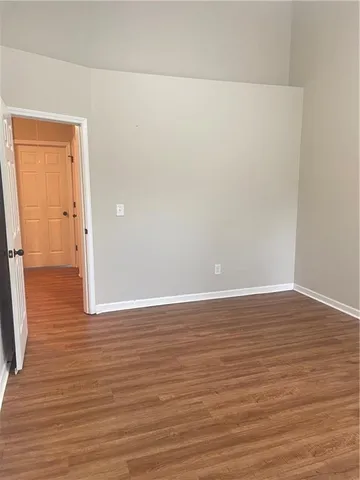 a view of a room with wooden floor