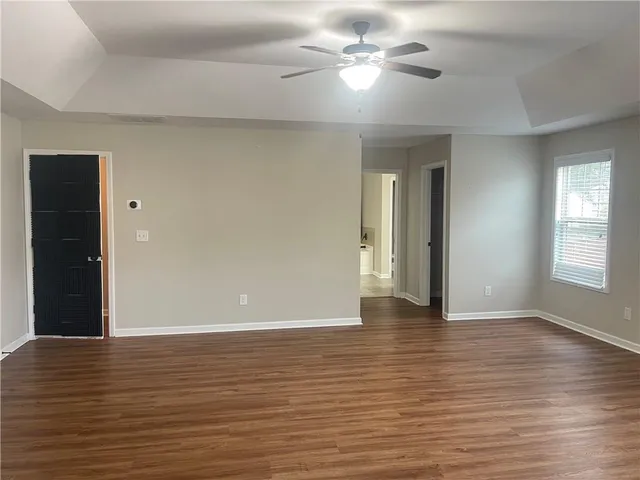 a view of an empty room with wooden floor