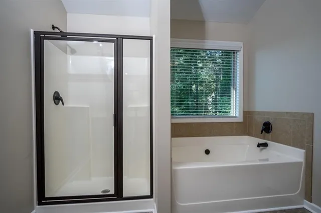 a bathroom with a bathtub and shower