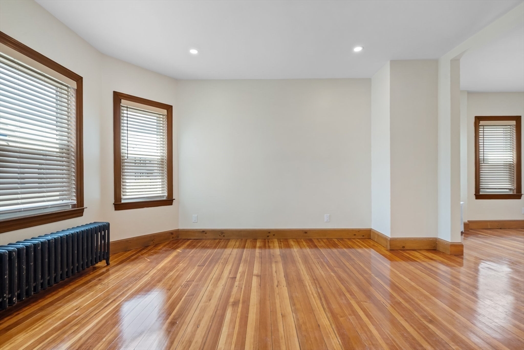 62 Vernal Street, Unit 3 Everett, MA 02149 - Photo 13 of 26 a view of a room with wooden floor and windows