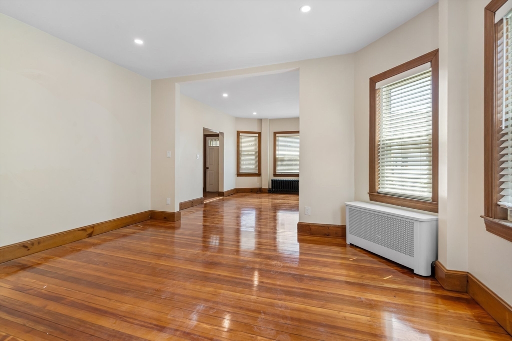 62 Vernal Street, Unit 3 Everett, MA 02149 - Photo 16 of 26 a view of empty room with wooden floor and fan