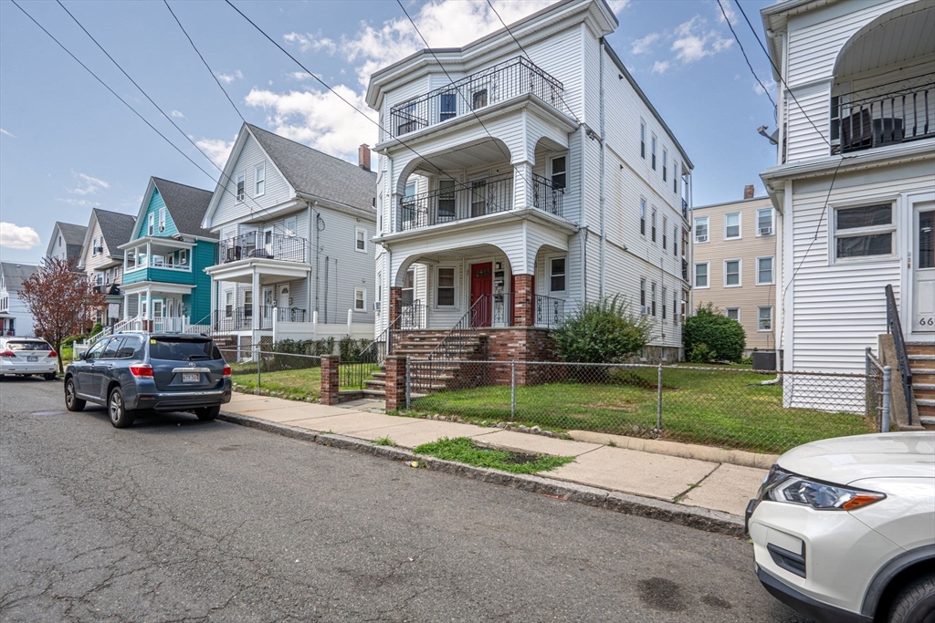 62 Vernal Street, Unit 3 Everett, MA 02149 - Photo 25 of 26 a view of multiple houses with a yard