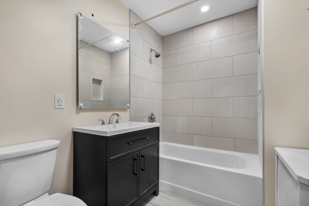 62 Vernal Street, Unit 3 Everett, MA 02149 - Photo 7 of 26 a bathroom with a sink toilet vanity and bathtub