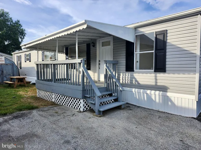 a view of a house with a wooden deck