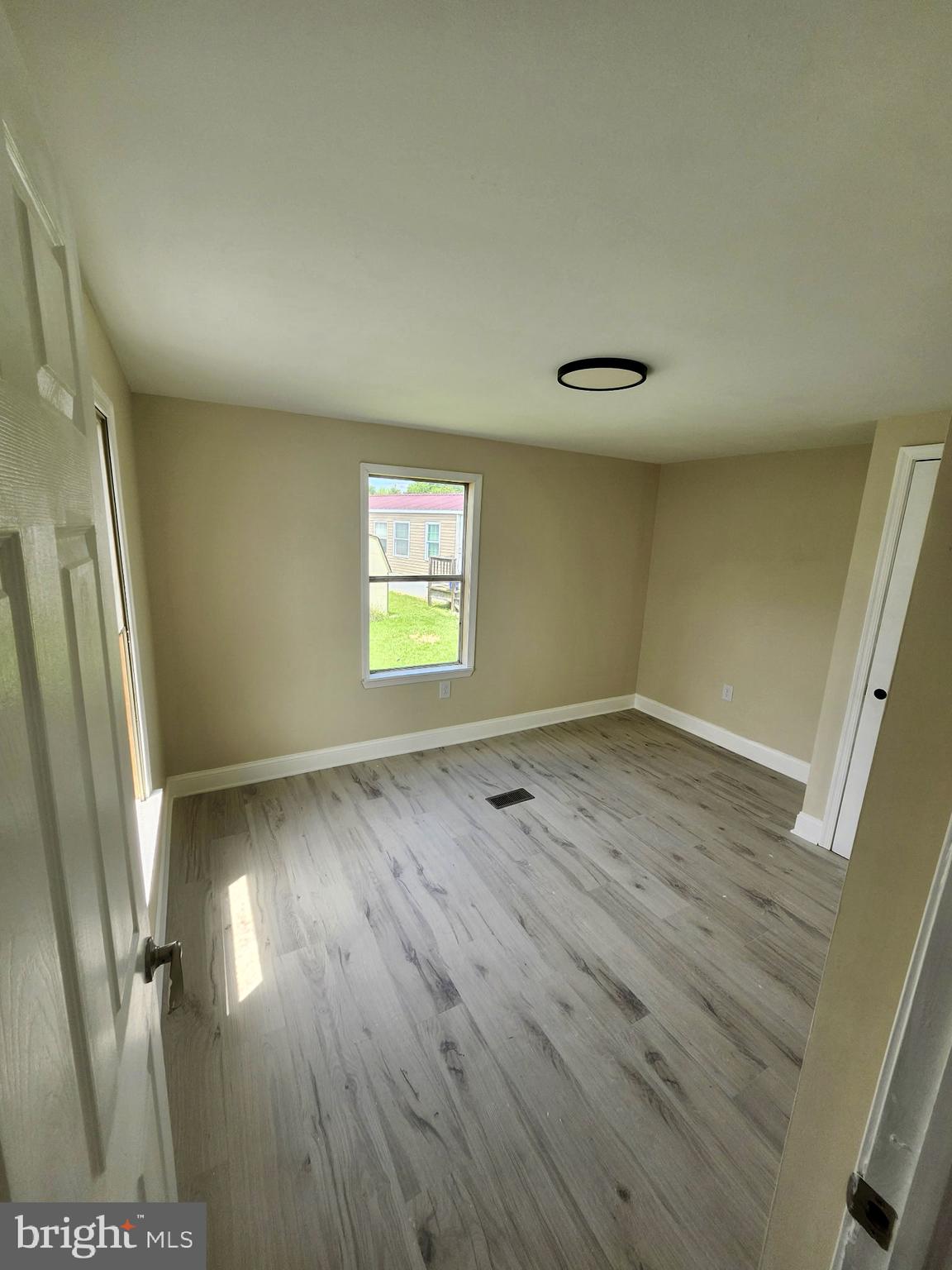 885 Buttonwood Avenue Spring City, PA 19475 - Photo 12 of 15 wooden floor in an empty room with a window