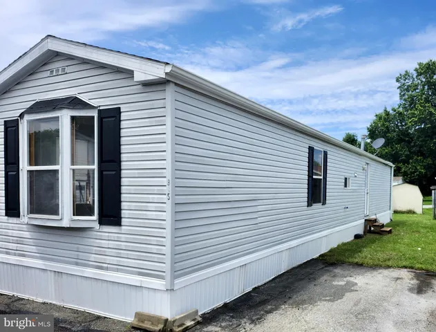 a view of a white house with many windows