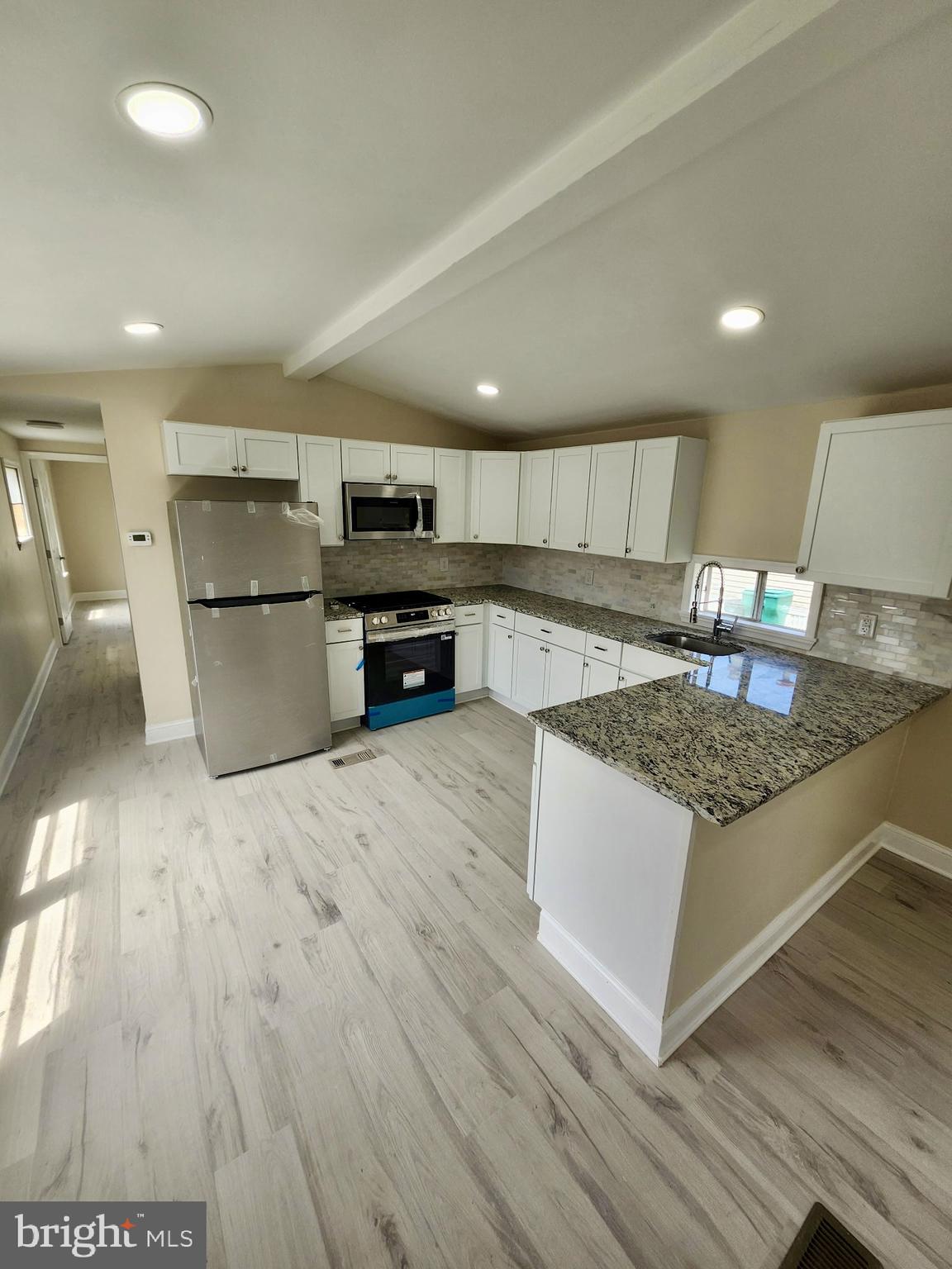 885 Buttonwood Avenue Spring City, PA 19475 - Photo 8 of 15 a kitchen with stainless steel appliances granite countertop a stove a sink and a microwave