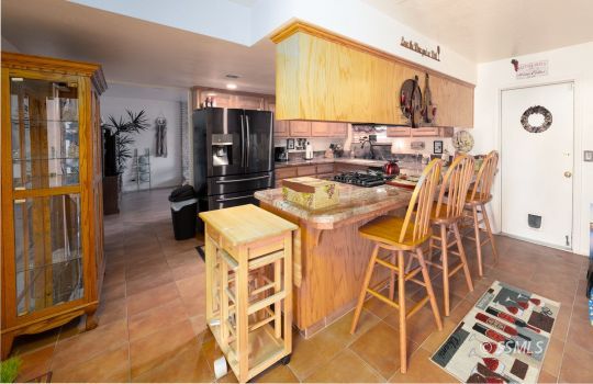 820 West Ward Avenue Ridgecrest, CA 93555 - Photo 10 of 26 a view of a kitchen with stainless steel appliances granite countertop a stove and a refrigerator