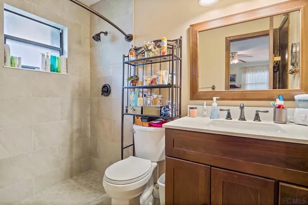 a bathroom with a sink vanity mirror and toilet