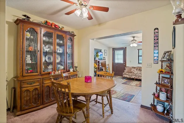 a view of a dining room with furniture and chandelier