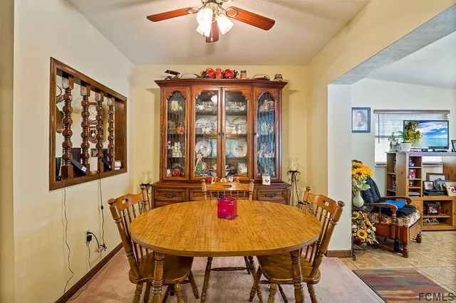 a very nice looking dining room with furniture window and outside view
