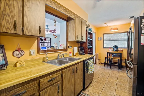 a kitchen with stainless steel appliances granite countertop a sink and cabinets