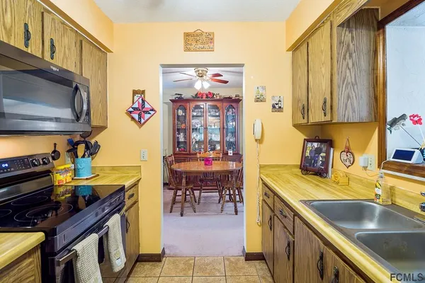 a kitchen with stainless steel appliances a stove a sink and a microwave